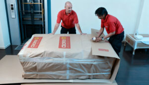 Crown Relocation wrapping a sofa-near a lift