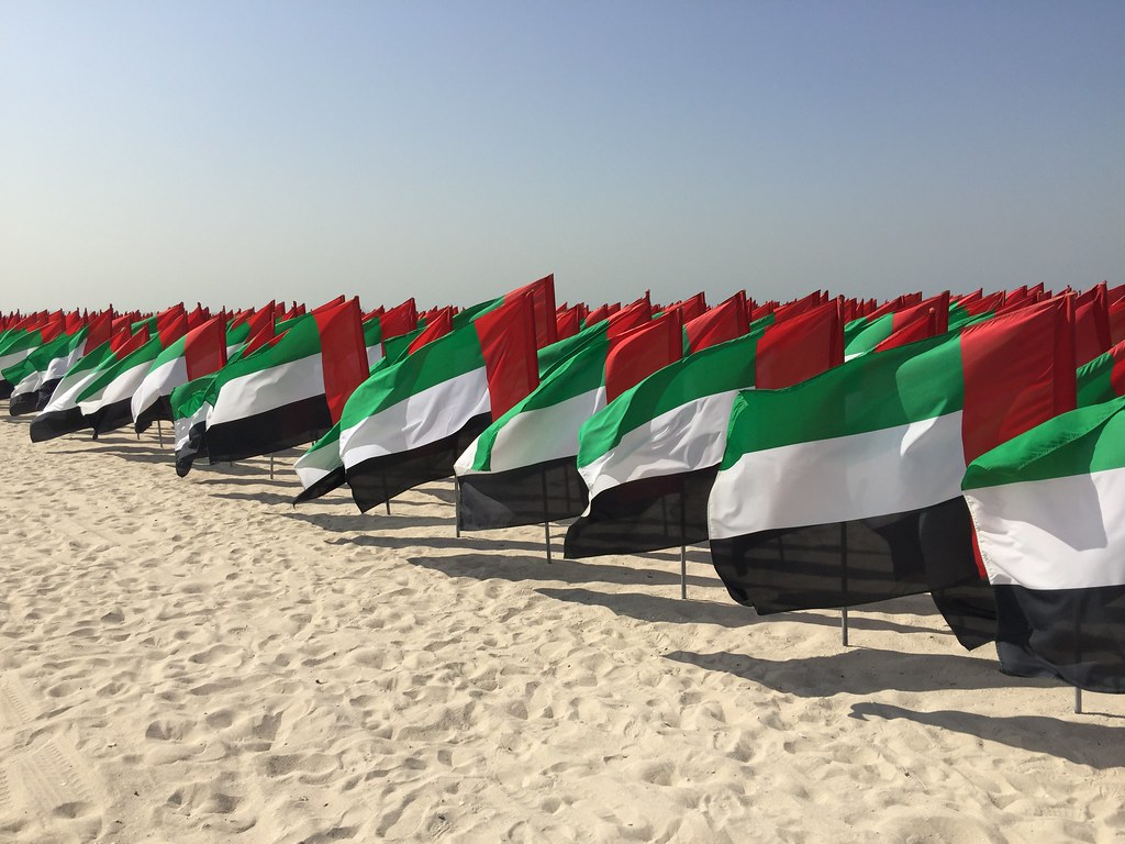 UAE flags on a beach near Dubai