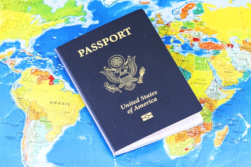 US passport sitting on map